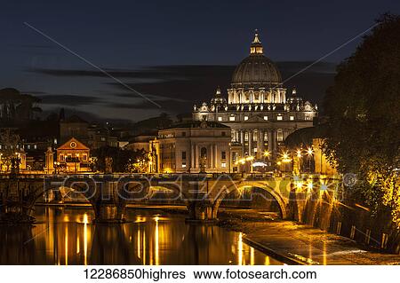 Stock Photograph - Saint Peter's Basilica, the world's largest church, at nighttime; Vatican City, Italy. Fotosearch