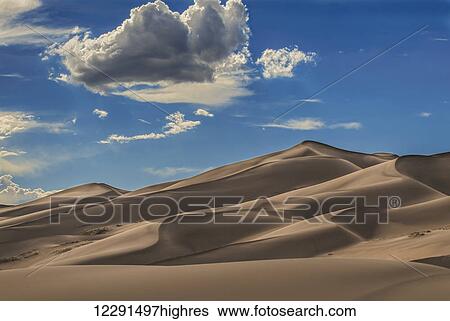 Sand dunes in afternoon sun at Great Sand Dunes National Park and Preserve; Colorado, United States of America View Large Photo Image Stock Photograph - Sand dunes in afternoon sun at Great Sand Dunes National Park and Preserve; Colorado, United States of America. Fotosearch