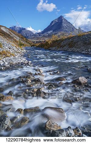 Stock Photograph - Scenic autumn view of Stonehouse Creek and the Three Guardsmen Mountains along the Haines Highway, British Columbia, Canada. Fotosearch