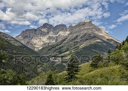 Stock Photograph - Scenic mountain view along the red rock canyon road, Waterton Lakes National Park; Alberta, Canada. Fotosearch