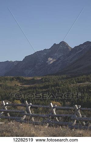 Scenic view of Chugach Mountains with a log fence in the foreground, Southcentral Alasak, Autumn View Large Photo Image Stock Photo - Scenic view of Chugach Mountains with a log fence in the foreground, Southcentral Alasak, Autumn. Fotosearch