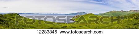 Stock Photograph - Scenic view of the green bluffs along the shore of Popof Island near Sand Point, Southwestern Alaska, USA, Summer. Fotosearch