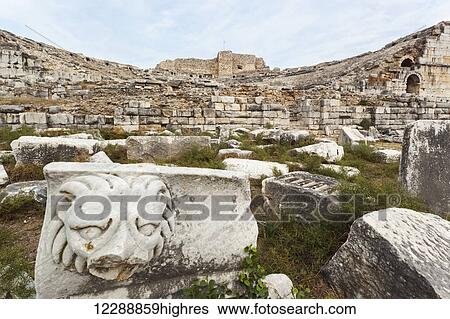 Stock Photograph - Sculpture of a lion at the ruins of an amphitheatre; Miletus, Turkey. Fotosearch