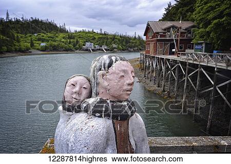Stock Photograph - Sculptures made from metal and wood adorn the boardwalk at The Saltry restaurant; Halibut Cove, Alaska, United States of America. Fotosearch