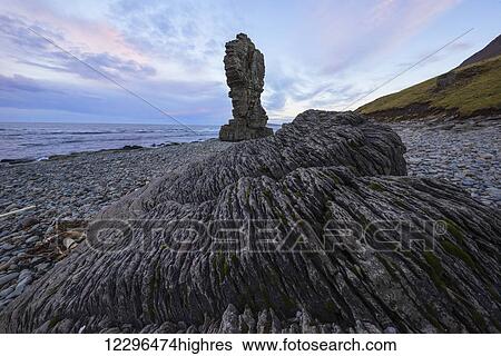 Sea stacks along the coast of Iceland's Westfjords as sunset begins; West Fjords, Iceland View Large Photo Image Stock Photograph - Sea stacks along the coast of Iceland's Westfjords as sunset begins; West Fjords, Iceland. Fotosearch