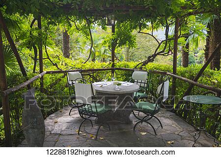 Stock Photograph - Seating on a restaurant patio; Locarno, Ticino, Switzerland. Fotosearch