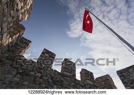 Stock Photograph - Selcuk Castle and the Turkish flag; Ephesus, Turkey. Fotosearch