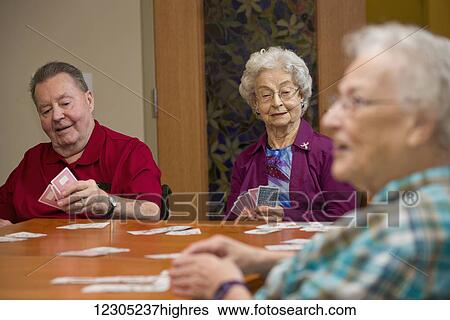 Stock Photograph - Senior citizens enjoying life in their shared residence; Edmonton, Alberta, Canada. Fotosearch