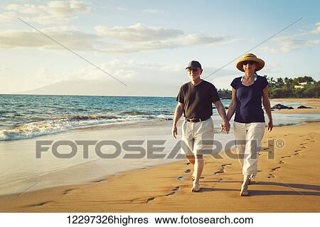 Senior Couple Enjoying Sunset at the Beach View Large Photo Image Stock Photograph - Senior Couple Enjoying Sunset at the Beach. Fotosearch