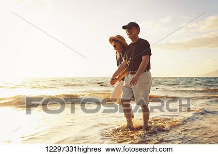 Senior Couple Enjoying Sunset at the Beach View Large Photo Image Stock Photograph - Senior Couple Enjoying Sunset at the Beach. Fotosearch