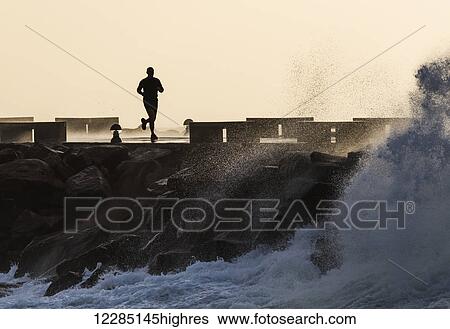 Silhouette of a man running along the coast; La Isla, Tarifa, Cadiz, Andalusia, Spain View Large Photo Image Stock Photograph - Silhouette of a man running along the coast; La Isla, Tarifa, Cadiz, Andalusia, Spain. Fotosearch