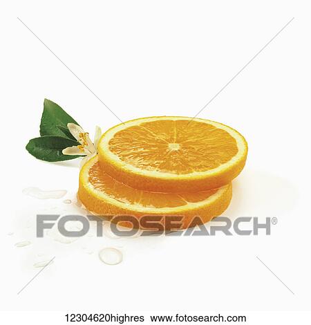 Stock Photograph - Slices of an orange on a white background; Toronto, Ontario, Canada. Fotosearch