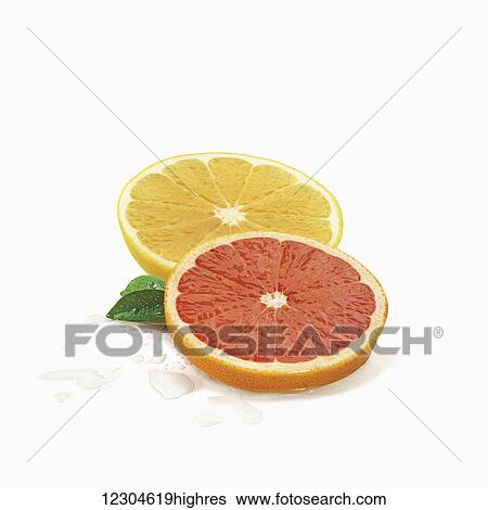 Stock Photograph - Slices of citrus fruit on a white background; Toronto, Ontario, Canada. Fotosearch