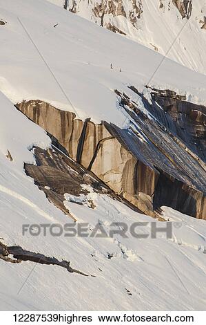 Snow covered cliffs bathed in sunset light, Kings Bay, Prince William Sound; Alaska, United States of America View Large Photo Image Stock Photograph - Snow covered cliffs bathed in sunset light, Kings Bay, Prince William Sound; Alaska, United States of America. Fotosearch