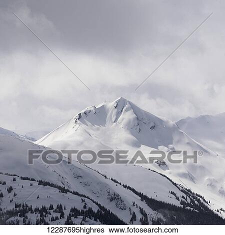 Stock Photograph - Snow covered mountain peak; Whistler, British Columbia, Canada. Fotosearch