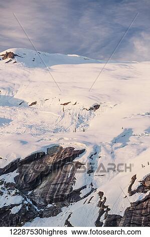 Snow covered peaks bathed in sunset light, Kings Bay, Prince William Sound; Whittier, Alaska, United States of America View Large Photo Image Stock Photograph - Snow covered peaks bathed in sunset light, Kings Bay, Prince William Sound; Whittier, Alaska, United States of America. Fotosearch