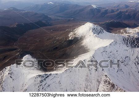 Stock Photograph - Snow covered peaks in the Brooks Range in winter; Alaska, United States of America. Fotosearch