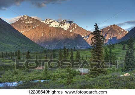 Stock Photograph - South Fork near Eagle River at sunset on a summer day in South Central Alaska.. Fotosearch