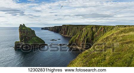 Stock Photograph - Stacks of Duncansby and the rugged coastline of Duncansby Head; Scotland. Fotosearch