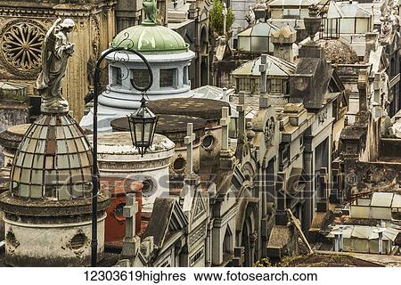 Stock Photograph - Statue of angel looking over Recoleta Cemetery; Buenos Aires, Argentina. Fotosearch