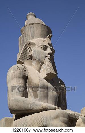 Statue of seated Ramses II, Court of Ramses II, Luxor Temple; Luxor, Egypt View Large Photo Image Stock Photo - Statue of seated Ramses II, Court of Ramses II, Luxor Temple; Luxor, Egypt. Fotosearch
