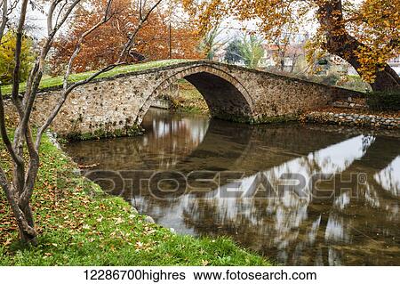 Stone bridge over a tranquil river; Edessa, Greece View Large Photo Image Stock Photograph - Stone bridge over a tranquil river; Edessa, Greece. Fotosearch