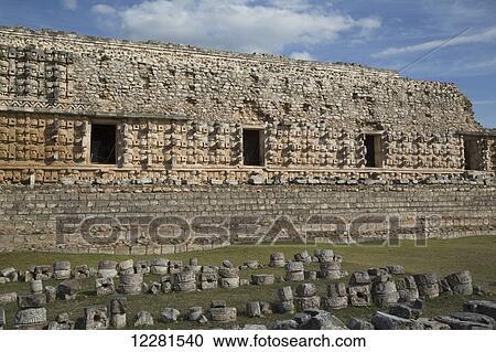 Stock Image - Stone glyphs in front of the Palace of Masks, Kabah archaeological site; Yucatan, Mexico. Fotosearch