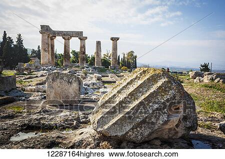 Stock Photograph - Stone ruins with columns and a boulder; Corinth, Greece. Fotosearch