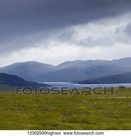 Storm clouds and fog over the mountainous landscape and water in the Highlands; Scotland View Large Photo Image Stock Photograph - Storm clouds and fog over the mountainous landscape and water in the Highlands; Scotland. Fotosearch