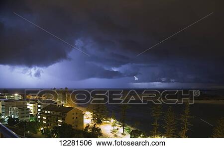 Stock Photograph - Storm clouds over a city; Caloundra, Queensland, Australia. Fotosearch