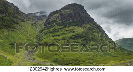 Storm clouds over rugged and foliage covered mountains; Scotland View Large Photo Image Stock Photograph - Storm clouds over rugged and foliage covered mountains; Scotland. Fotosearch