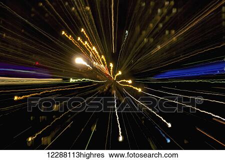 Stock Photograph - Streaks of multi-coloured light at nighttime. Fotosearch