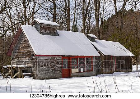 Stock Photograph - Sugar house in spring with snow; Waterloo, Quebec, Canada. Fotosearch