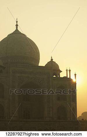 Stock Photograph - Sun rising over Taj Mahal; Agra, Uttar Pradesh, India. Fotosearch