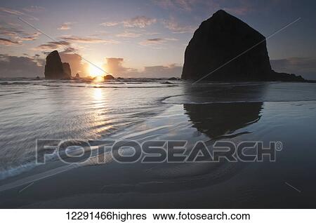 Stock Photograph - Sunset behind Haystack Rock; Cannon Beach, Oregon, United States of America. Fotosearch