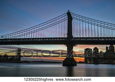 Sunset behind Manhattan and Brooklyn Bridges; New York City, New York, United States of America View Large Photo Image Stock Photograph - Sunset behind Manhattan and Brooklyn Bridges; New York City, New York, United States of America. Fotosearch