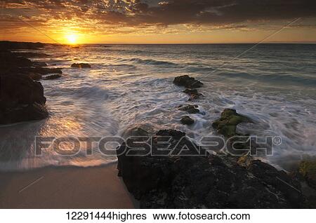 Stock Photograph - Sunset on the Kona-Kailoa Coast; Island of Hawaii, Hawaii, United States of America. Fotosearch
