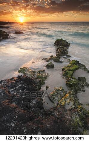 Stock Photograph - Sunset on the Kona-Kailoa Coast of Hawaii; Kona, Island of Hawaii, Hawaii, United States of America. Fotosearch