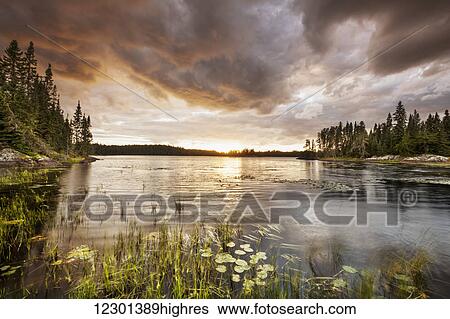 Stock Photograph - Sunset over a pond; Thunder Bay, Ontario, Canada. Fotosearch