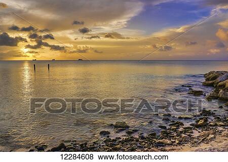 Stock Photo - Sunset over Dickenson Bay; St. John's, Antigua, West Indies. Fotosearch