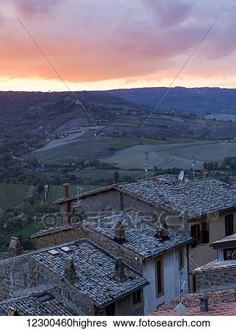 Sunset over farmland with houses in the foreground; Orvieto, Umbria, Italy View Large Photo Image Stock Photograph - Sunset over farmland with houses in the foreground; Orvieto, Umbria, Italy. Fotosearch