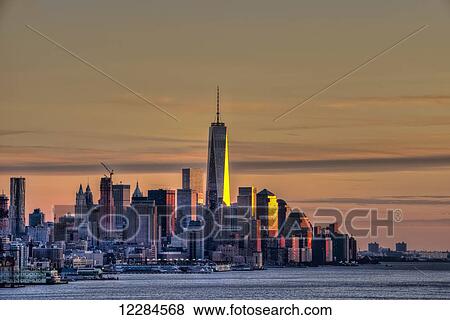 Stock Photo - Sunset over Lower Manhattan and the World Trade Centre; New York City, New York, United States of America. Fotosearch