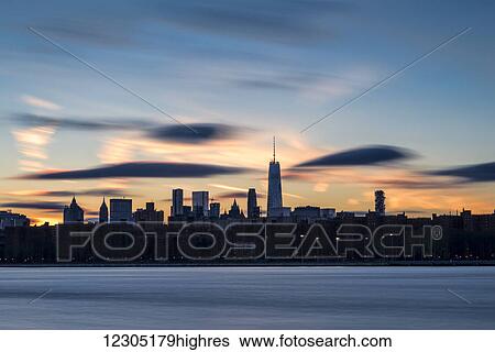 Stock Photograph - Sunset over Lower Manhattan and World Trade Center; New York City, New York, United States of America. Fotosearch