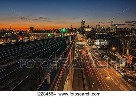 Sunset over Sunnyside, Queens with Manhattan in background; New York City, New York, United States of America View Large Photo Image Picture - Sunset over Sunnyside, Queens with Manhattan in background; New York City, New York, United States of America. Fotosearch