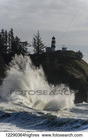 Stock Photograph - Surf breaks at Cape Disappointment Lighthouse; Ilwaco, Washington, United States of America. Fotosearch