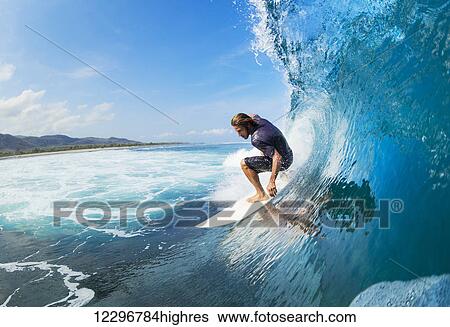 Surfer on Blue Ocean Wave in the Tube Getting Barreled View Large Photo Image Stock Photograph - Surfer on Blue Ocean Wave in the Tube Getting Barreled. Fotosearch