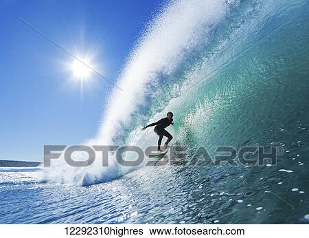 Stock Photograph - Surfer On Blue Ocean Wave. Fotosearch
