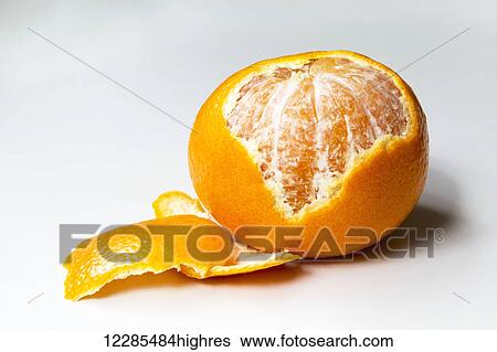 Stock Photograph - Tangerine with part of peel removed; Chilliwack, British Columbia, Canada. Fotosearch