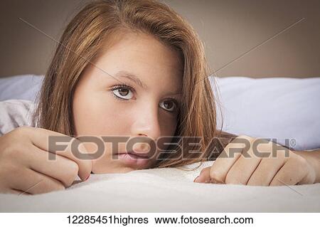 Teenage girl on her bed View Large Photo Image Stock Photograph - Teenage girl on her bed. Fotosearch