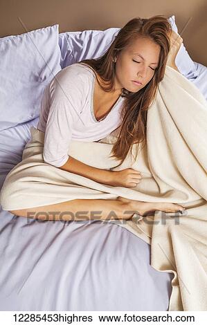 Teenage girl on her bed View Large Photo Image Stock Photograph - Teenage girl on her bed. Fotosearch